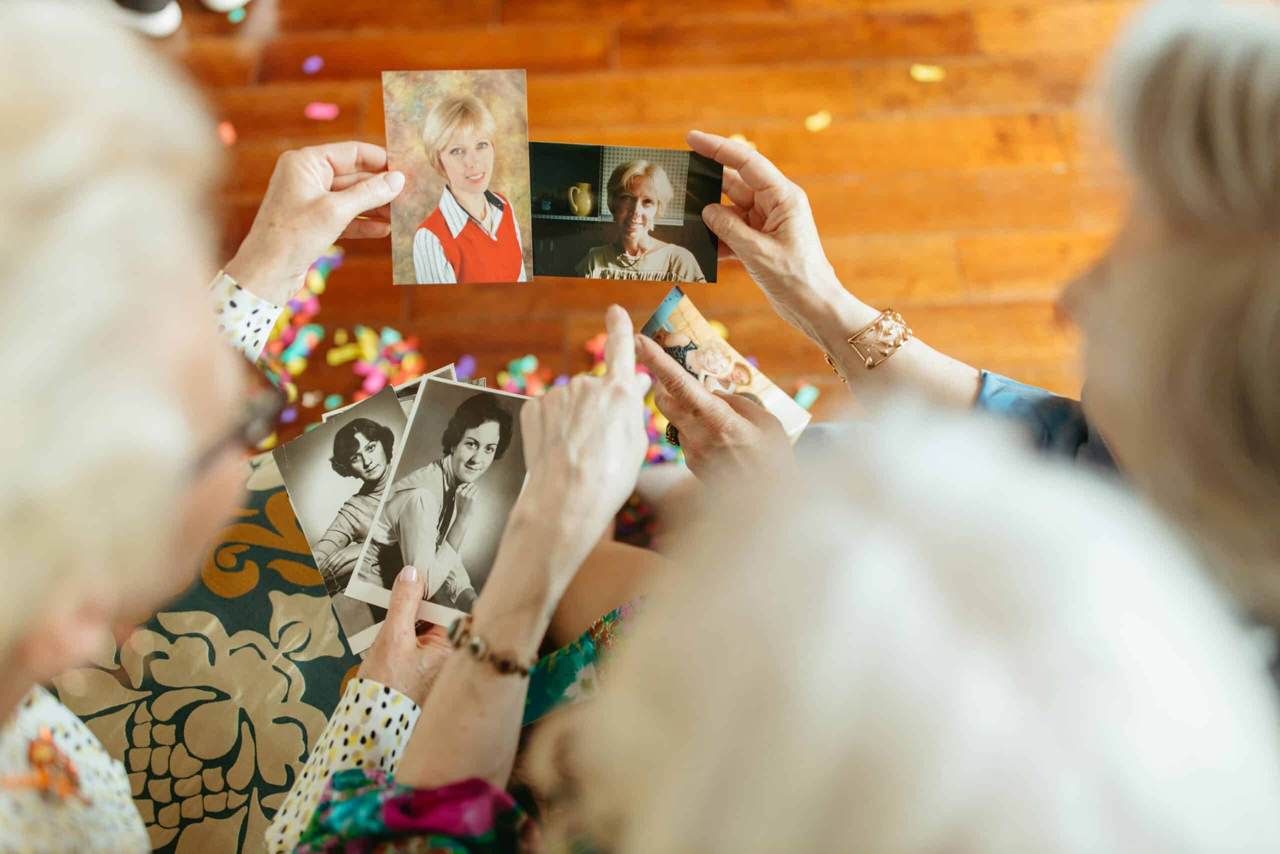 Three old friends looking at images of their past. Something that helps people living with dementia reminisce about the good old times.