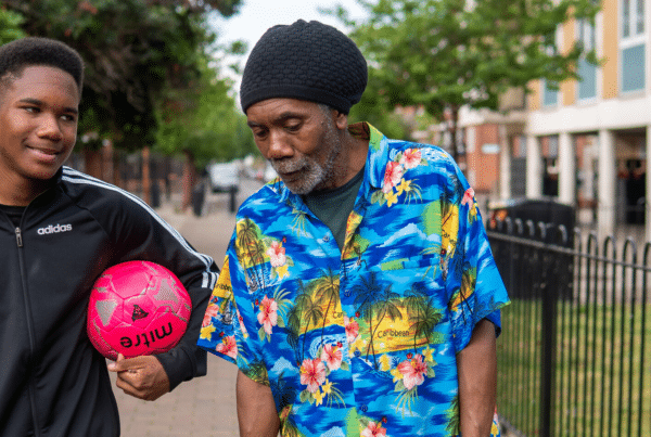 Young man and his dad on their way to play football.