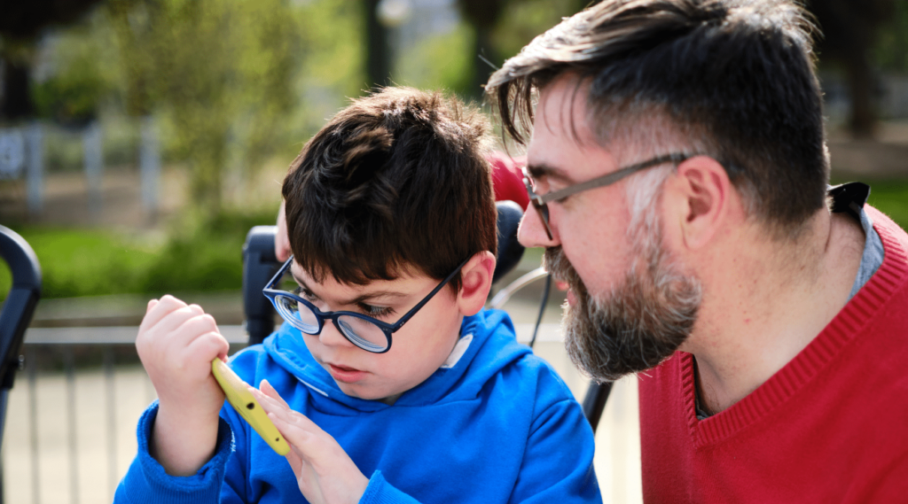 A child and his dad in the park.