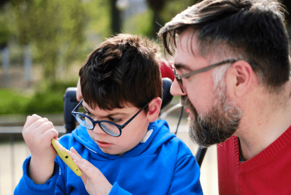 A child and his dad in the park.