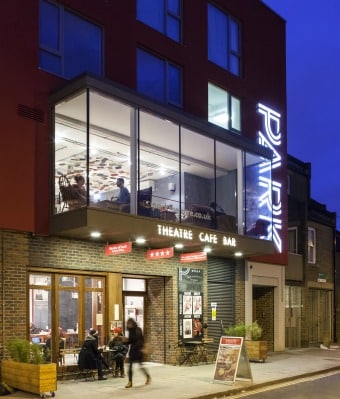 Facade of Park Theatre building lit up at night