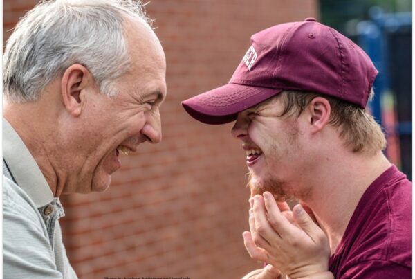 Older man with greying hair and young man with Downs syndrome
