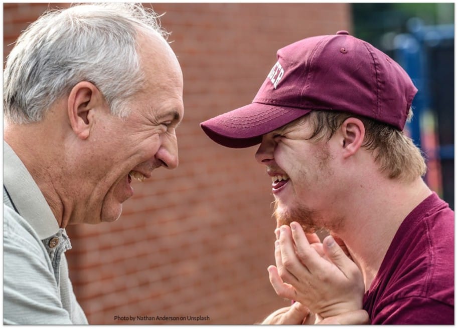 Older man with greying hair and young man with Downs syndrome