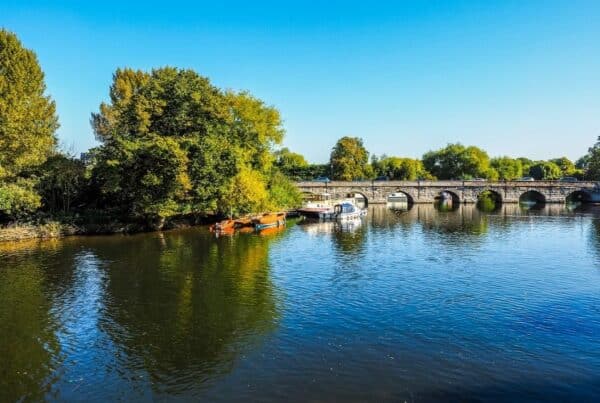 Stratford upon Avon bridge and river with blue sky and boat