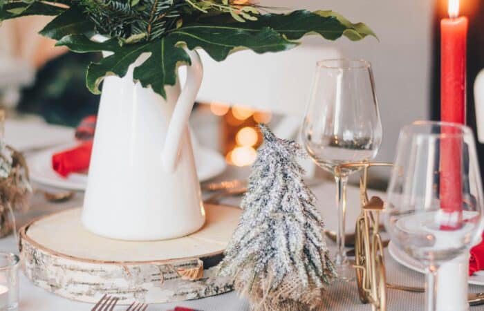 White-clothed table with festive decor.